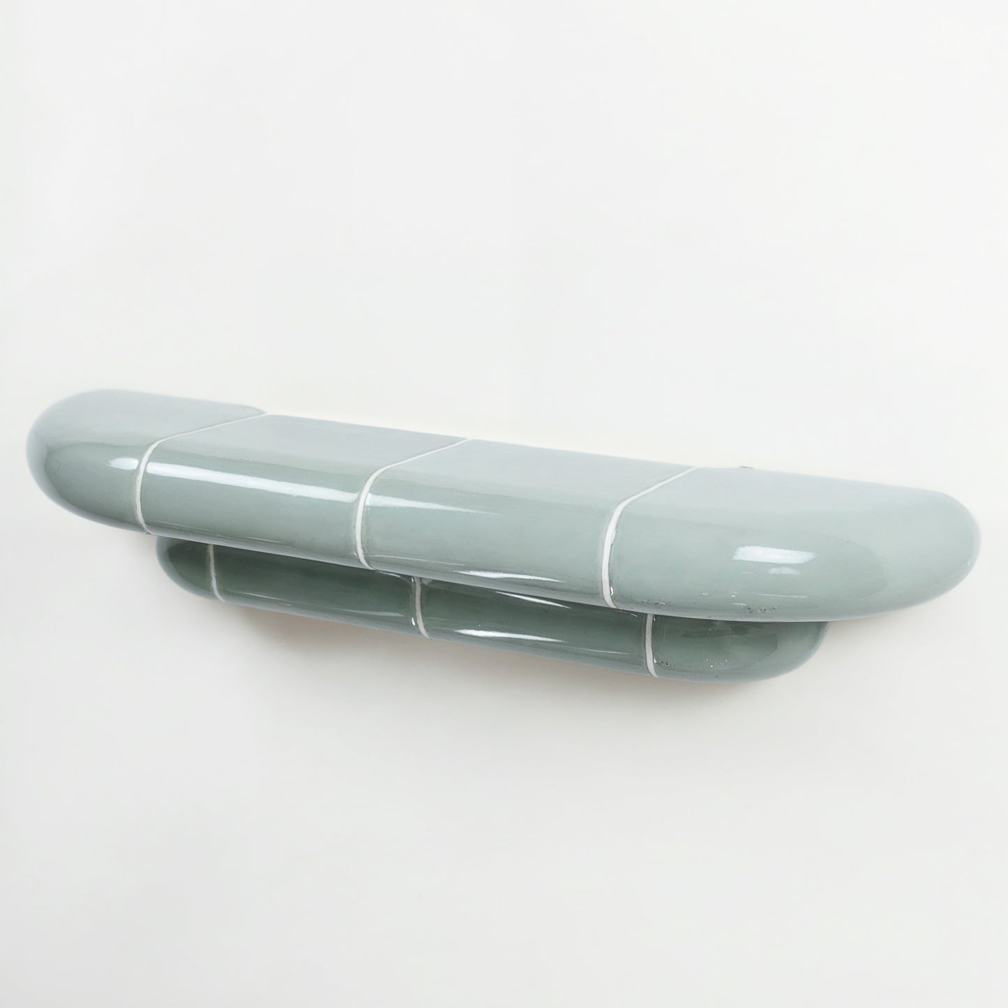 Orbi designer floating shelf in glossy Pastel Mint finish, handcrafted in Spain.