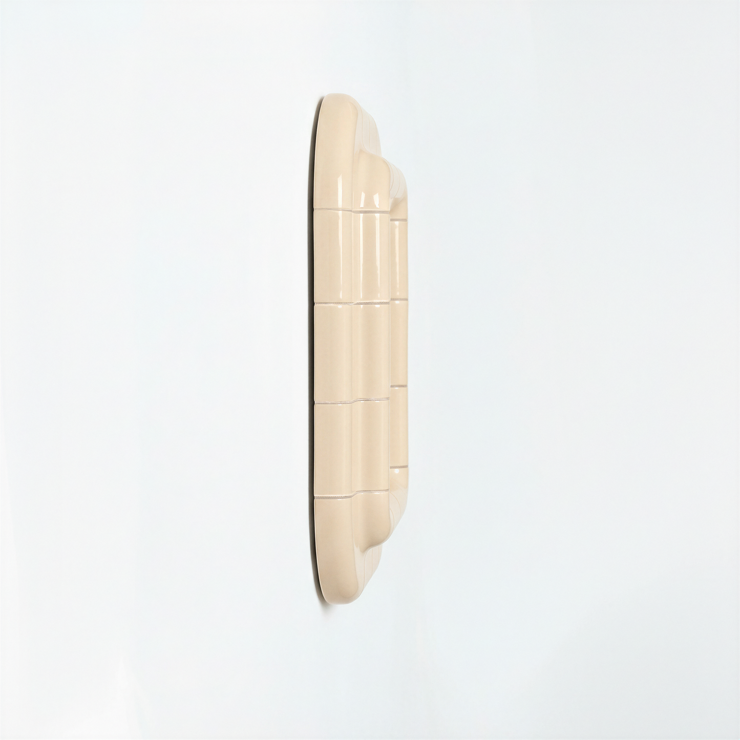 Side view of a Soft Butter ceramic-inspired mirror, revealing its depth, layered form, and smooth glossy finish.