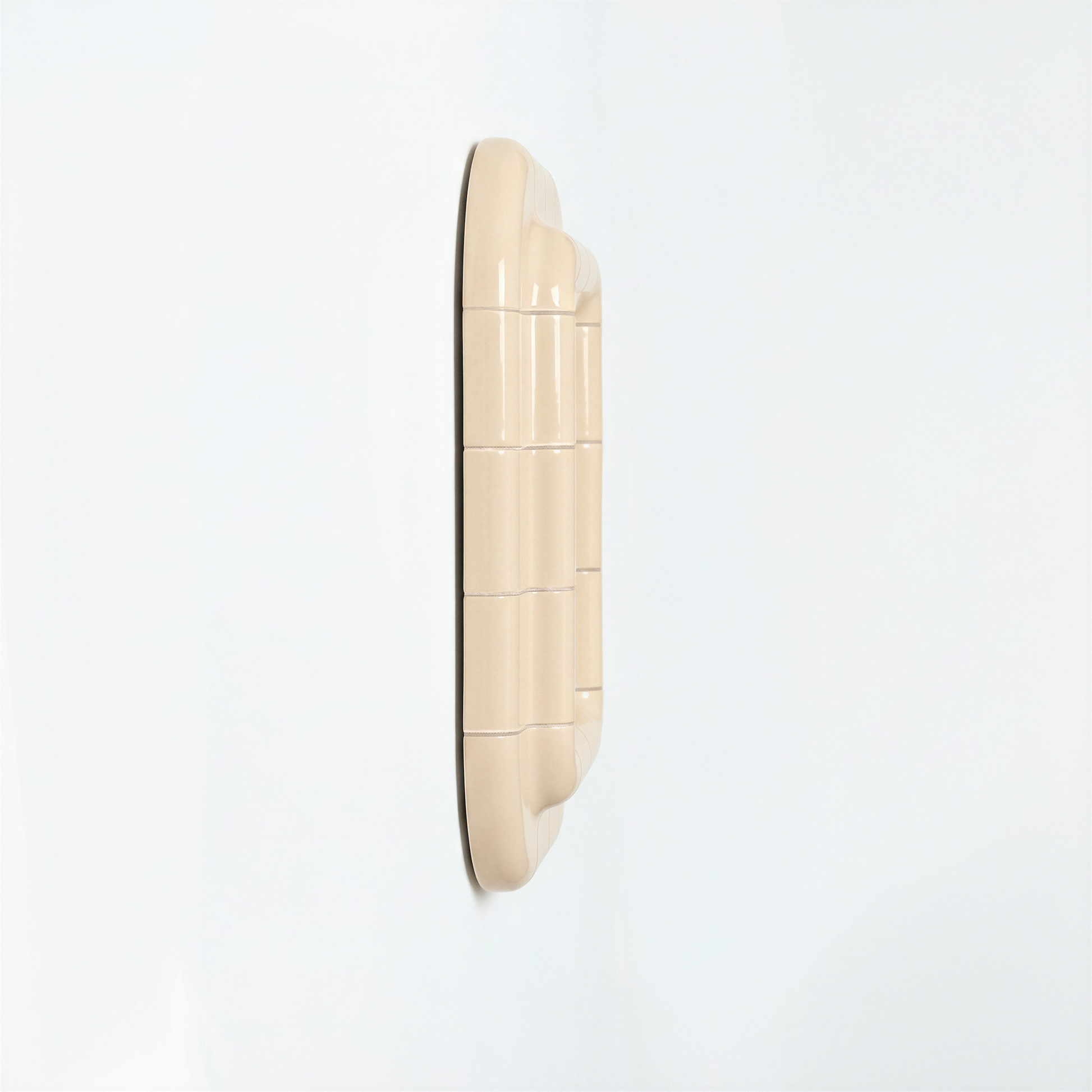 Side view of a Soft Butter ceramic-inspired mirror, revealing its depth, layered form, and smooth glossy finish.