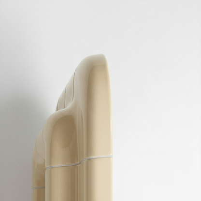 Detailed side profile of a Soft Butter ceramic-look mirror, emphasizing its sculptural thickness and curved geometry.