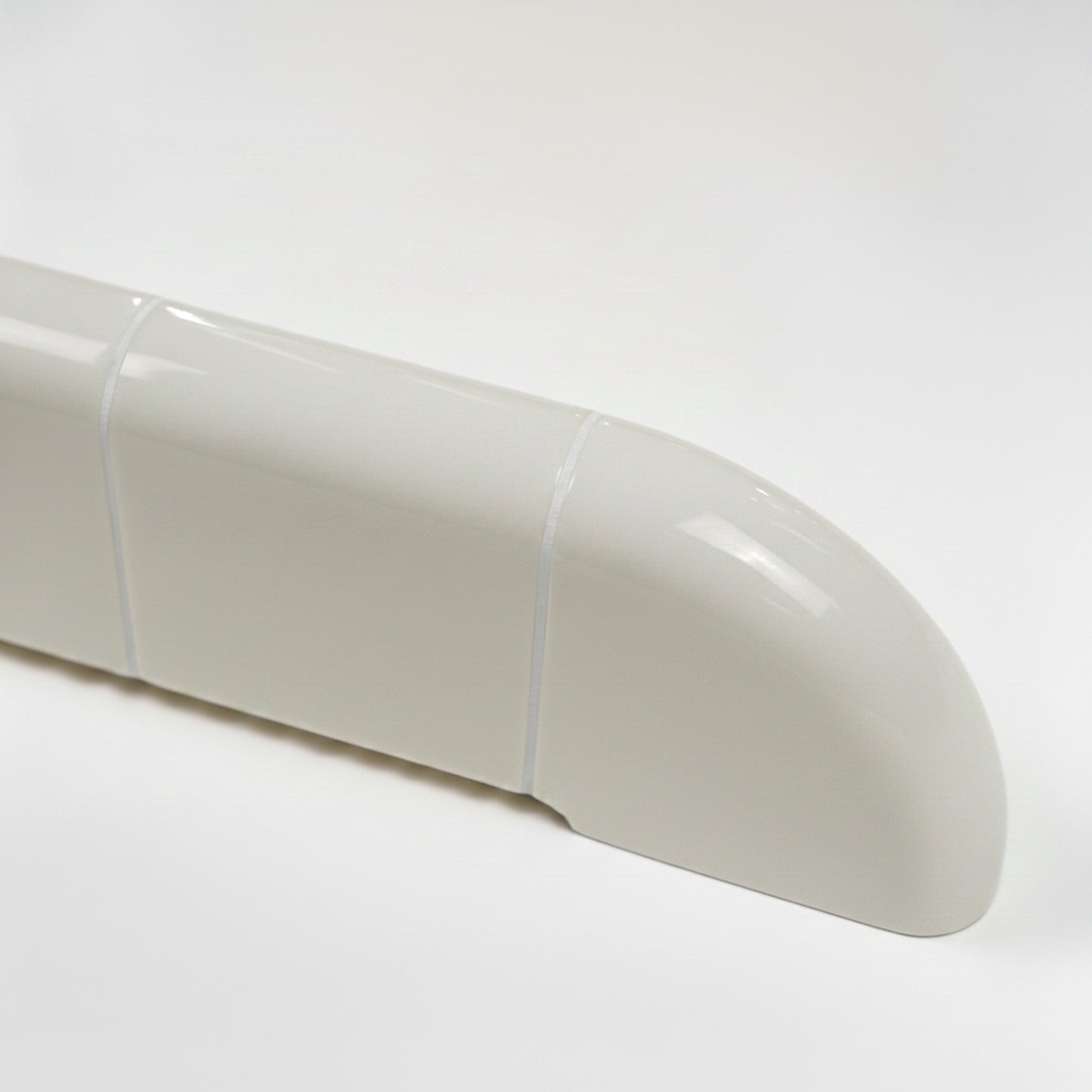 Close-up of the Orbi wall shelf showing the glossy Off-White finish and rounded ceramic-inspired details.