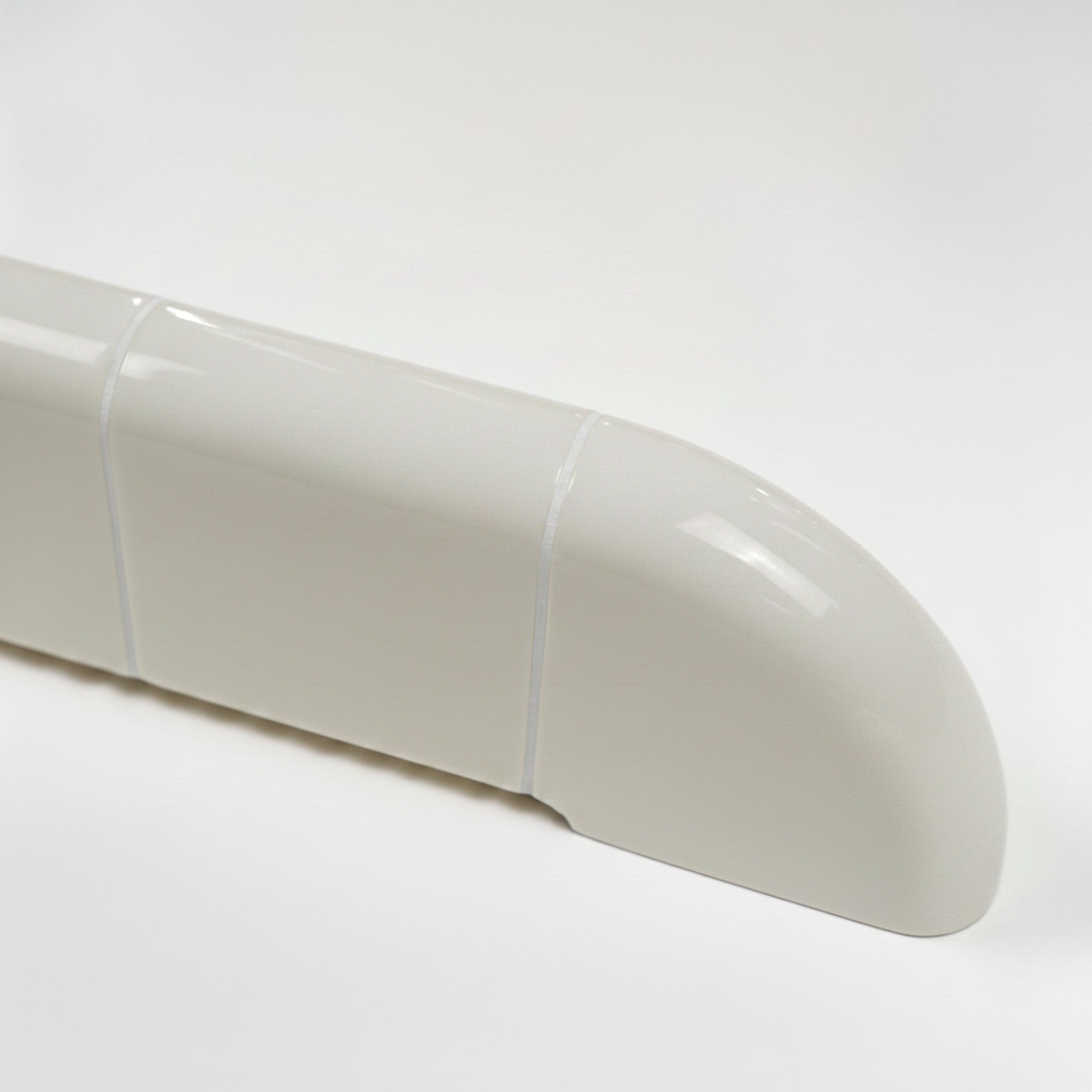 Close-up of the Orbi wall shelf showing the glossy Off-White finish and rounded ceramic-inspired details.