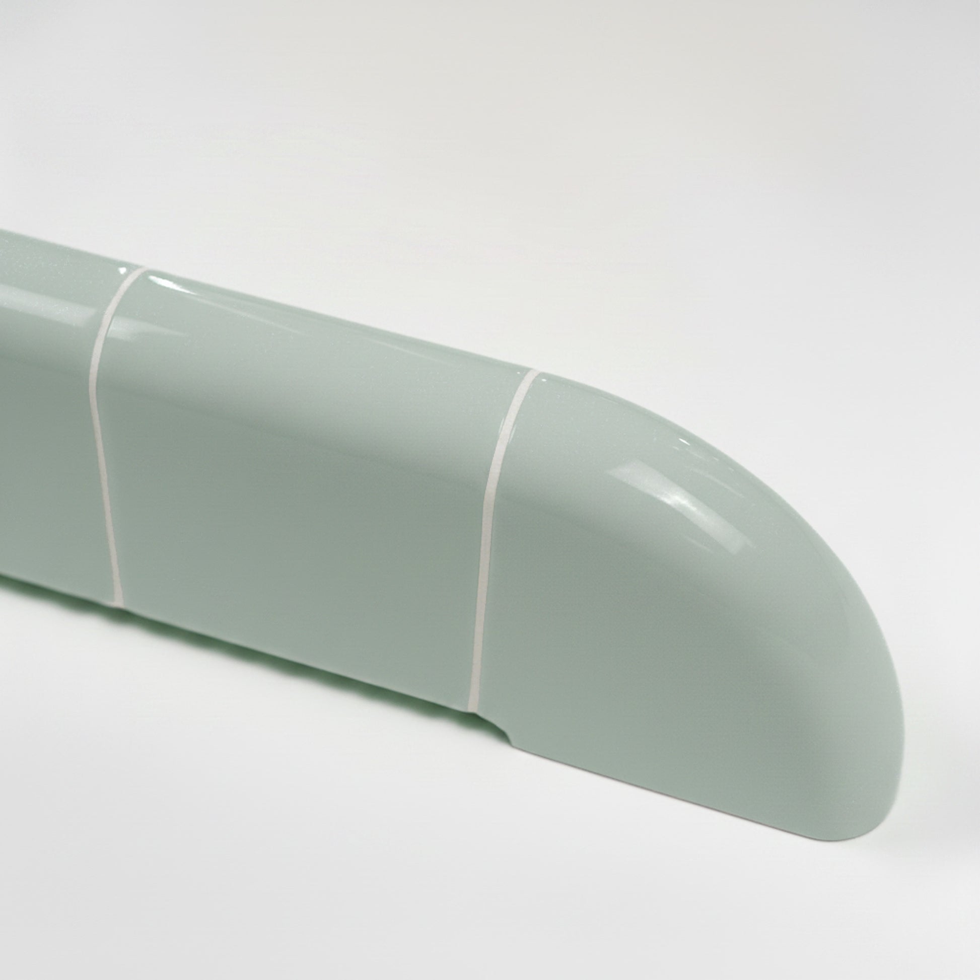 Detail of the Orbi wall shelf in glossy Pastel Mint, featuring smooth rounded edges and ceramic-inspired craftsmanship.