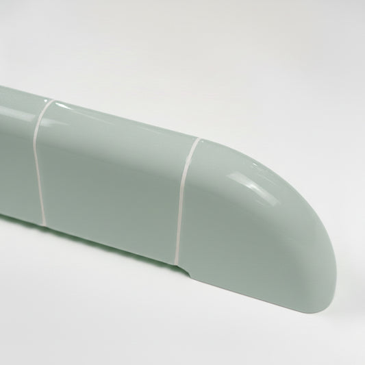Detail of the Orbi wall shelf in glossy Pastel Mint, featuring smooth rounded edges and ceramic-inspired craftsmanship.