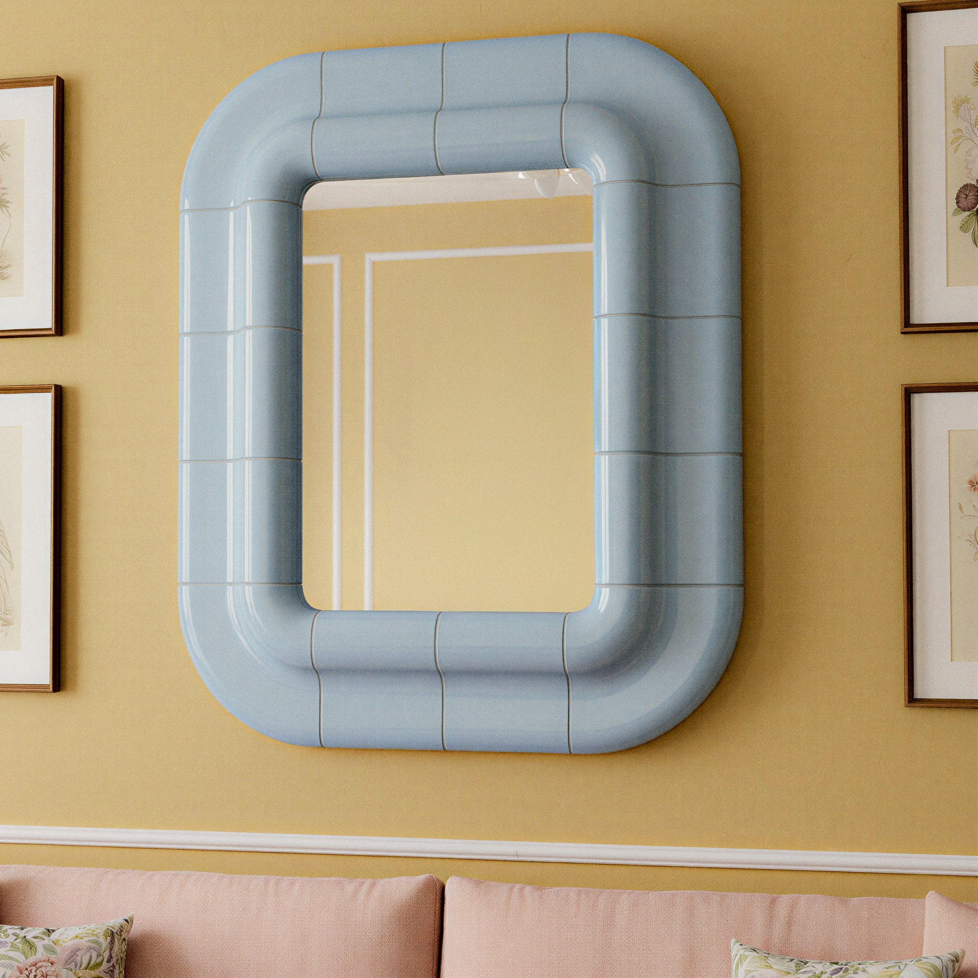 Ice Blue ceramic-look mirror with rounded rectangular frame, 3/4 perspective in context.