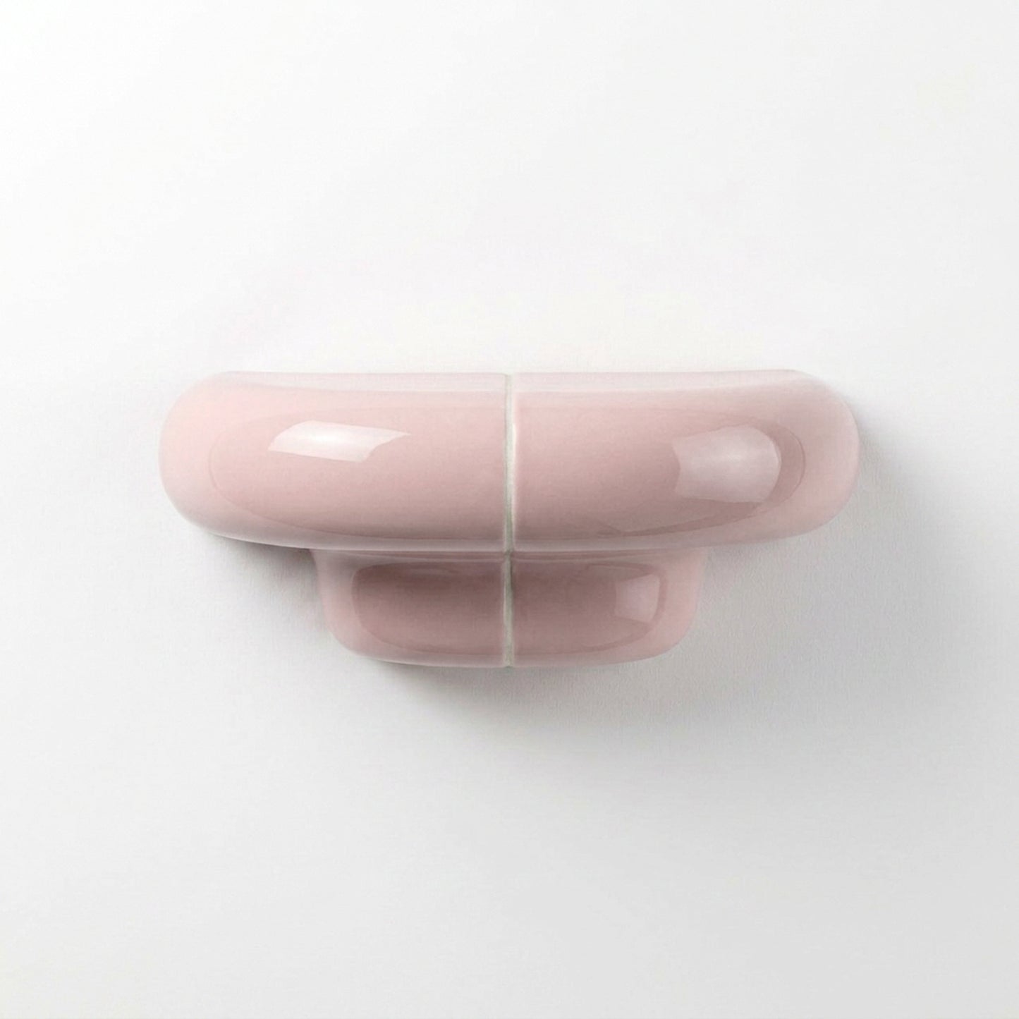 Orbi XS designer floating shelf in glossy Blush Pink, compact handcrafted shelf for contemporary interiors.