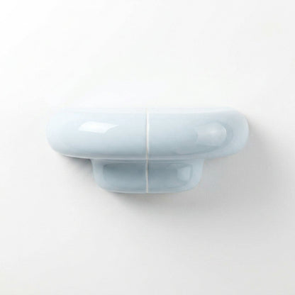 Orbi XS designer shelf in glossy Ice Blue, compact floating shelf for modern spaces.