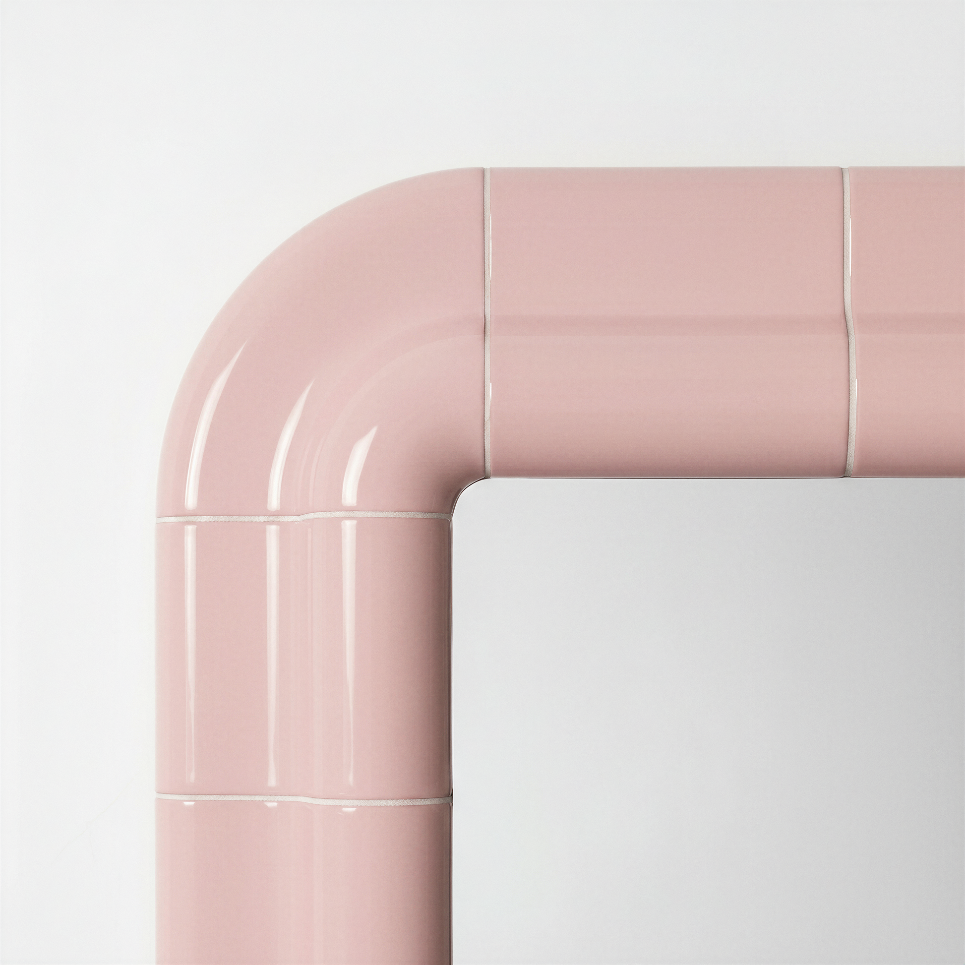 Detail of the rounded corner and ceramic-inspired joints of the blush pink mirror frame.
