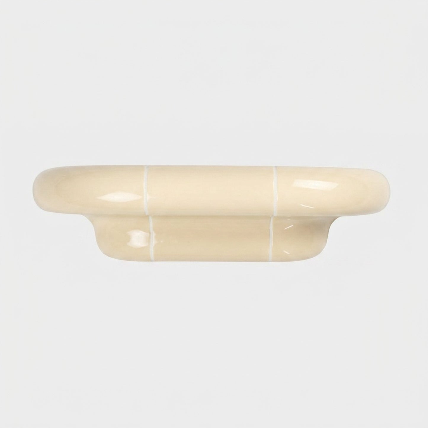 Orbi S modular wall shelf in glossy Soft Butter with a sculptural ceramic-inspired design.