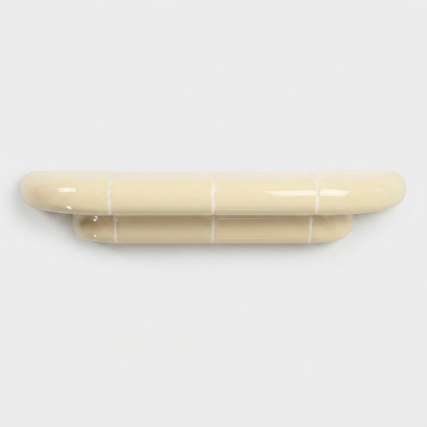 Orbi M floating shelf in glossy Soft Butter, handcrafted designer shelf with rounded forms.