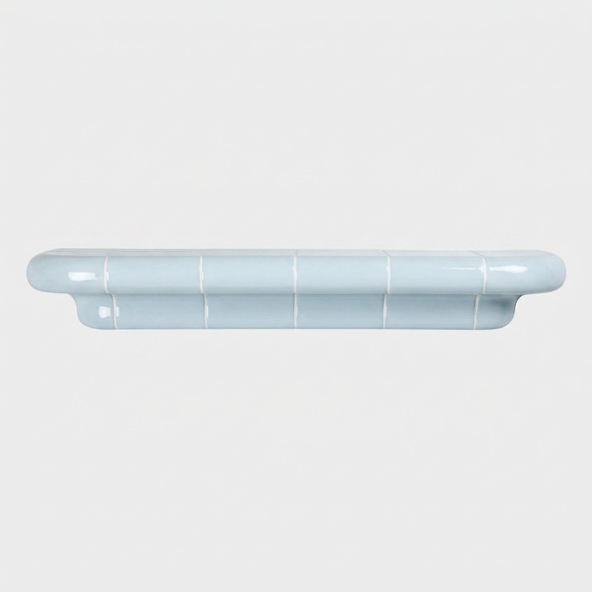 Orbi XL handcrafted shelf in glossy Ice Blue with a minimalist sculptural silhouette.
